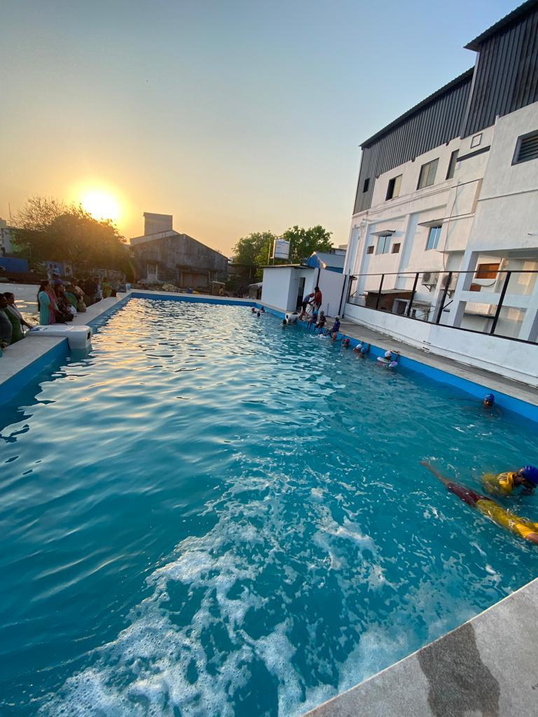Resort Pool at Sunset — Guest pool with wooden decking